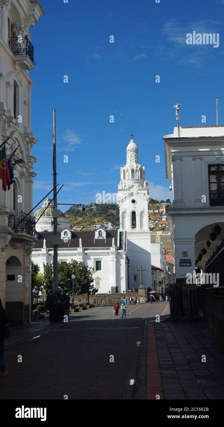 Quito, Pichincha / Ecuador - September 16 2018: People walking near the Metropolitan Cathedral of Quito with the Virgin of El Panecillo in the backgro Stock Photo
