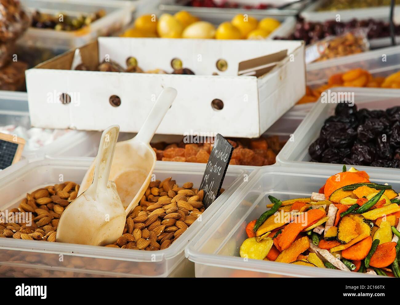 Natures almonds (Amandes natures in French) and dried vegetables at the local market Stock Photo