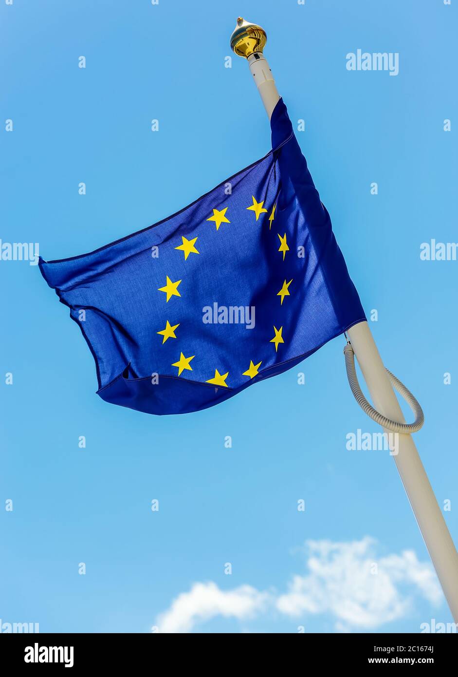 flag of the European Union with clouds underneath symbolizing darkening Stock Photo