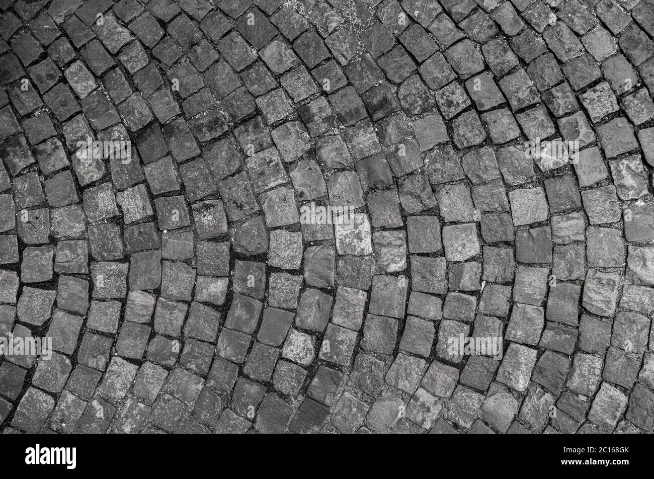 Stone pavement texture. Granite cobble stoned pavement background. Abstract background of old cobblestone pavement close-up Stock Photo