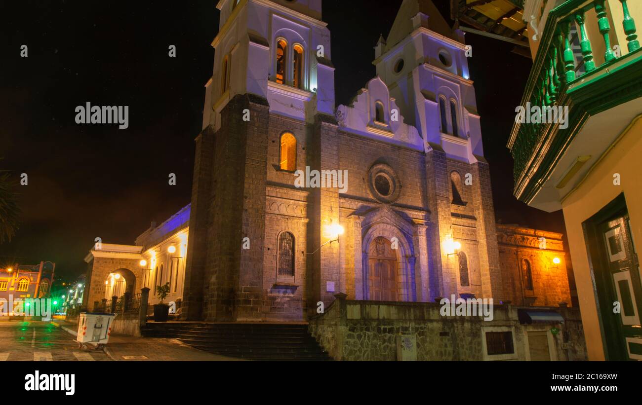 Guaranda, Bolivar / Ecuador - October 18 2019: Night view of the front of San Pedro de Guaranda Cathedral Church illuminated with yellow and purple li Stock Photo
