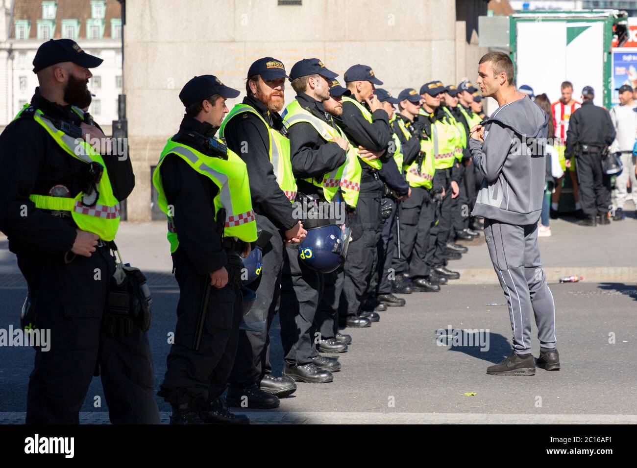 A far-right counter-protester confronts a police officer beside Westminster Bridge, London, 13 June 2020 Stock Photo