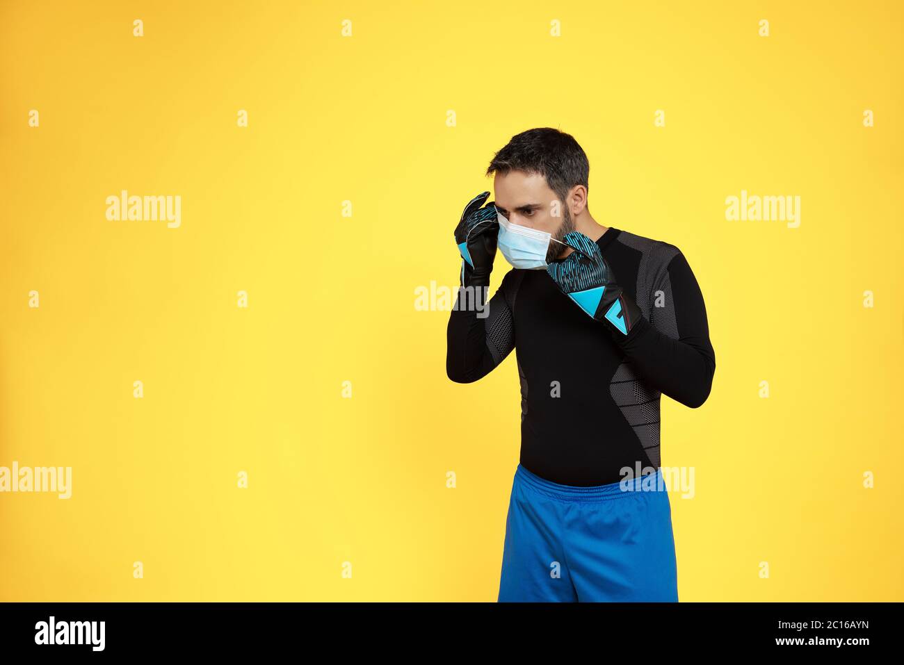 Download Football Soccer Goalkeeper Removing His Mask From His Face Due To The Covid19 Coronavirus Pandemic On A Yellow Background Stock Photo Alamy PSD Mockup Templates