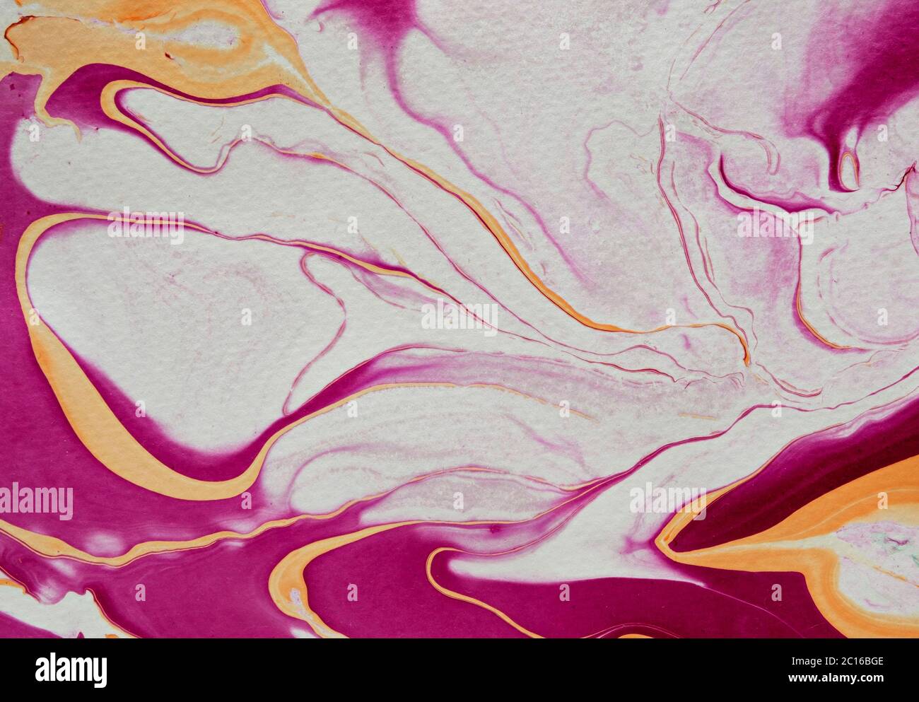DIY fluid marbling abstract background with free flowing magenta, white and golden yellow in full frame Stock Photo