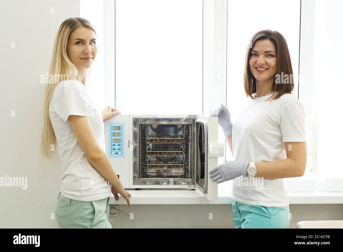 Dry heat for sterilization instruments. Two friendly women - masters of a beauty salon Stock Photo