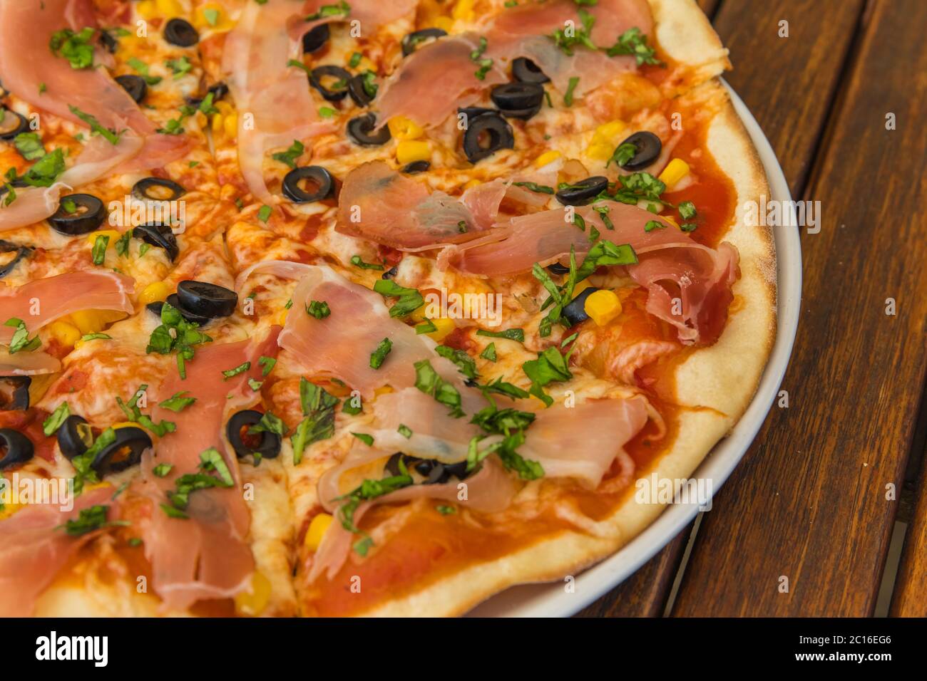 Tasty hot italian pizza with ham, mushrooms and olives. Traditional Italian  food. Concept poster for Restaurants or pizzerias Stock Photo - Alamy