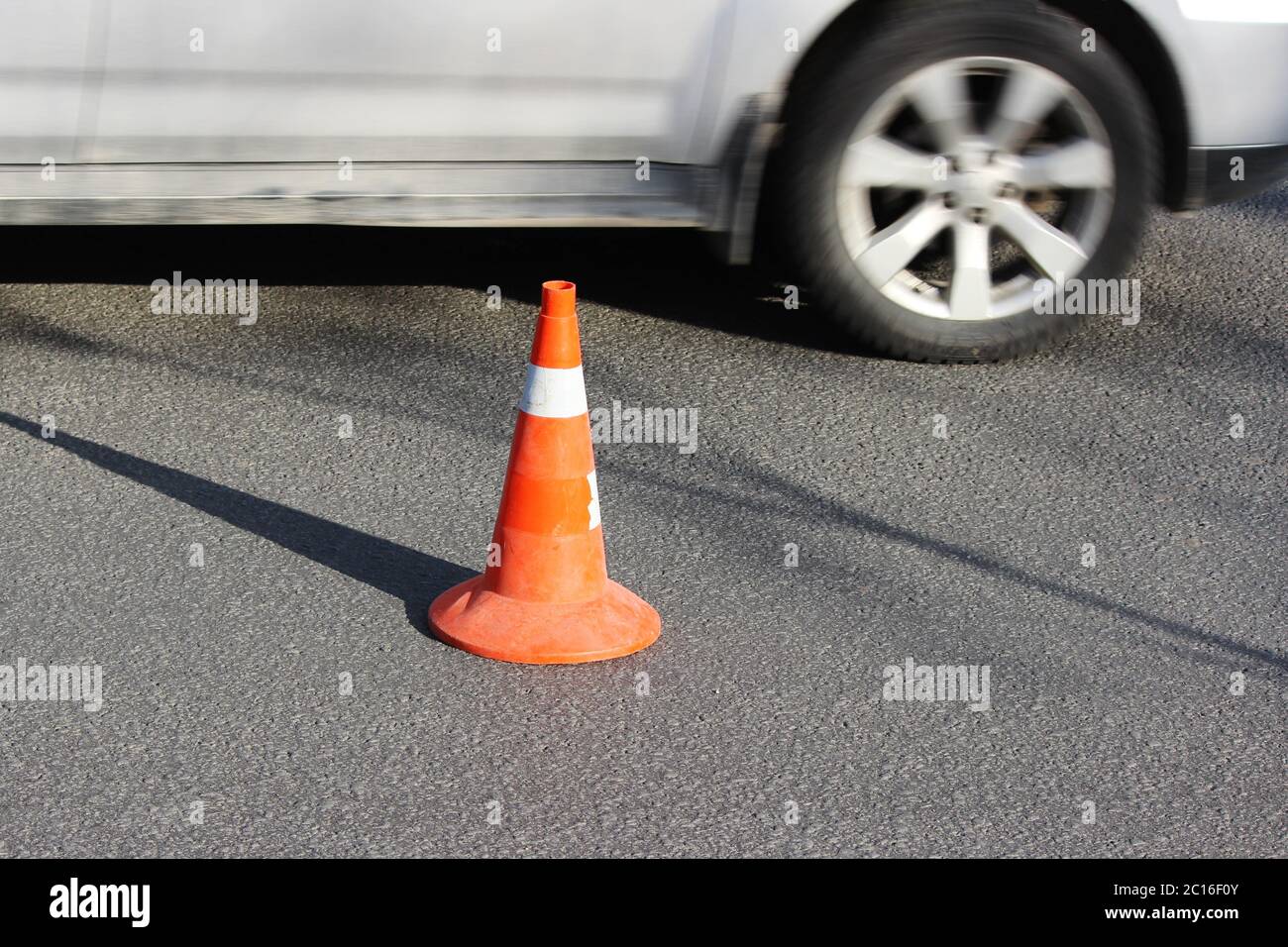 plastic signaling traffic cone encloses a place in the parking lot for trucks. Stock Photo