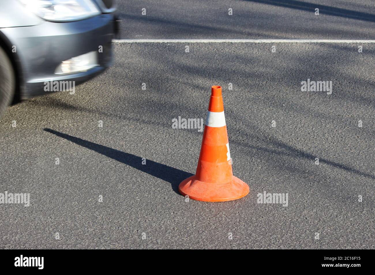 plastic signaling traffic cone encloses a place in the parking lot for trucks. Stock Photo