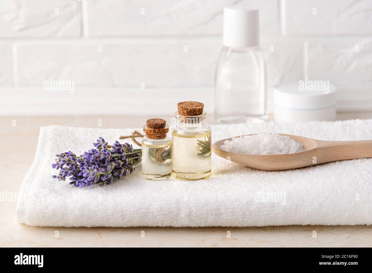 https://c8.alamy.com/comp/2C16F90/fresh-fragrant-lavender-lavender-essential-oil-and-cosmetic-bath-salt-on-a-white-terry-towel-in-a-bathroom-home-made-spa-skincare-and-cosmetology-2C16F90.jpg