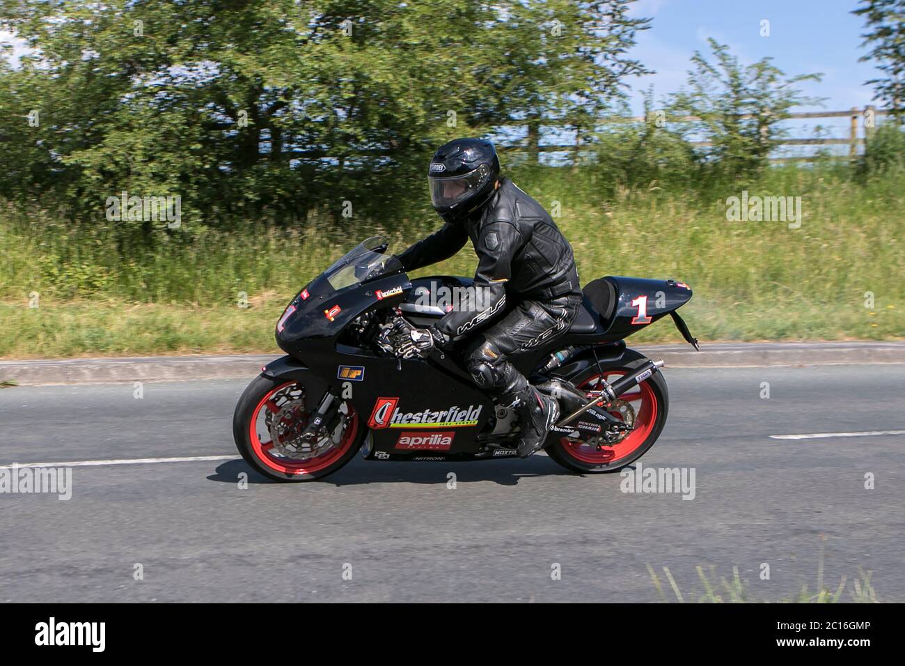 A motorbike rider driving a sponsored Aprilla RS 125 Pro Chesterfields near Chorley in Lancashire, UK Stock Photo