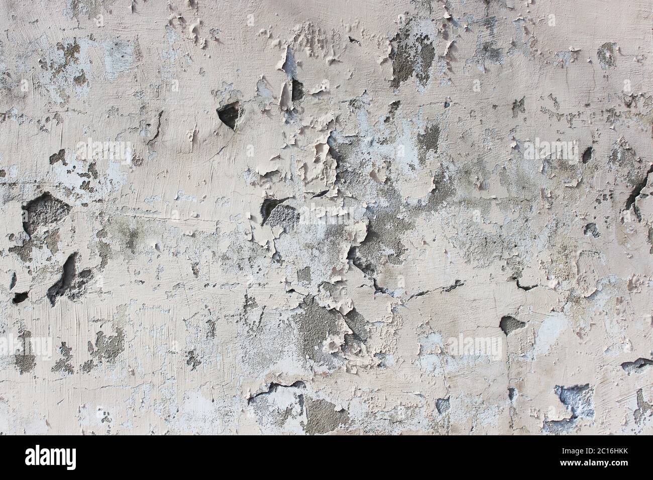 old beige wall with peeling plaster for background Stock Photo