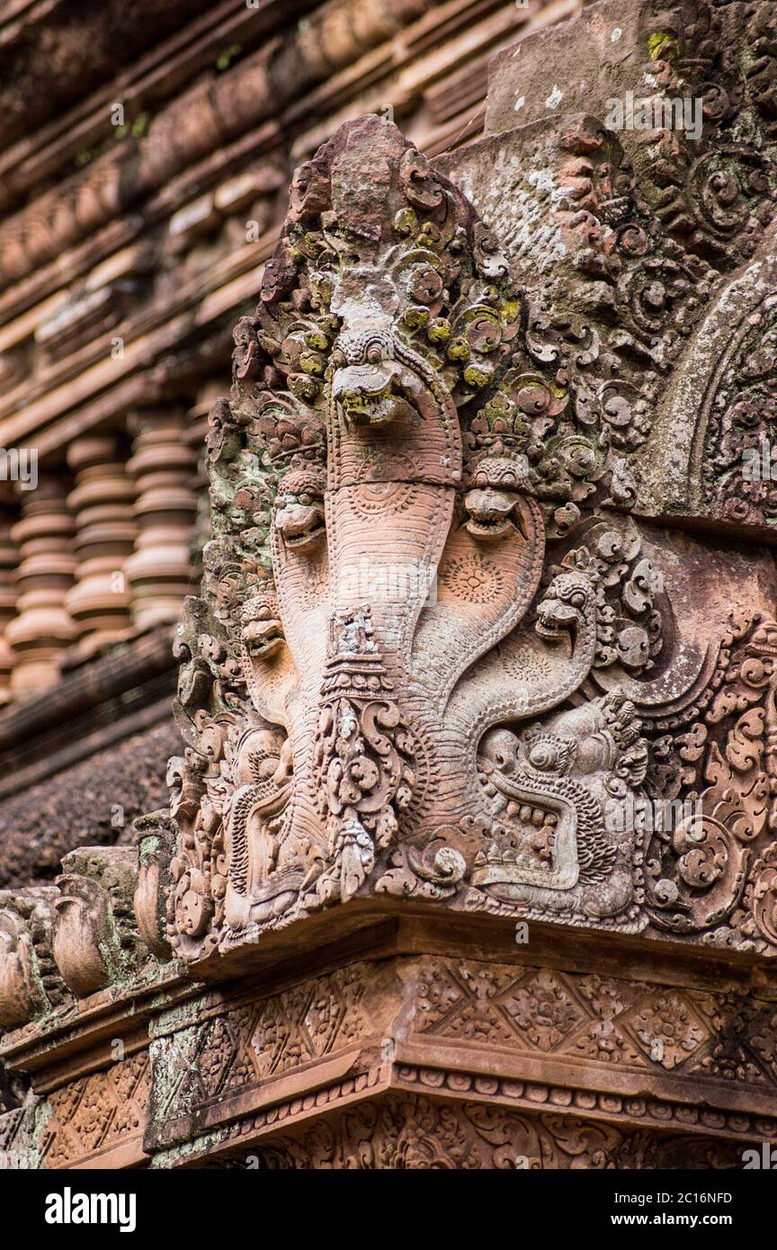 Ornate carving of a Naga, Hindu snake god, on the corner of a prasat at Banteay Srei Temple, Angkor, Cambodia. Stock Photo