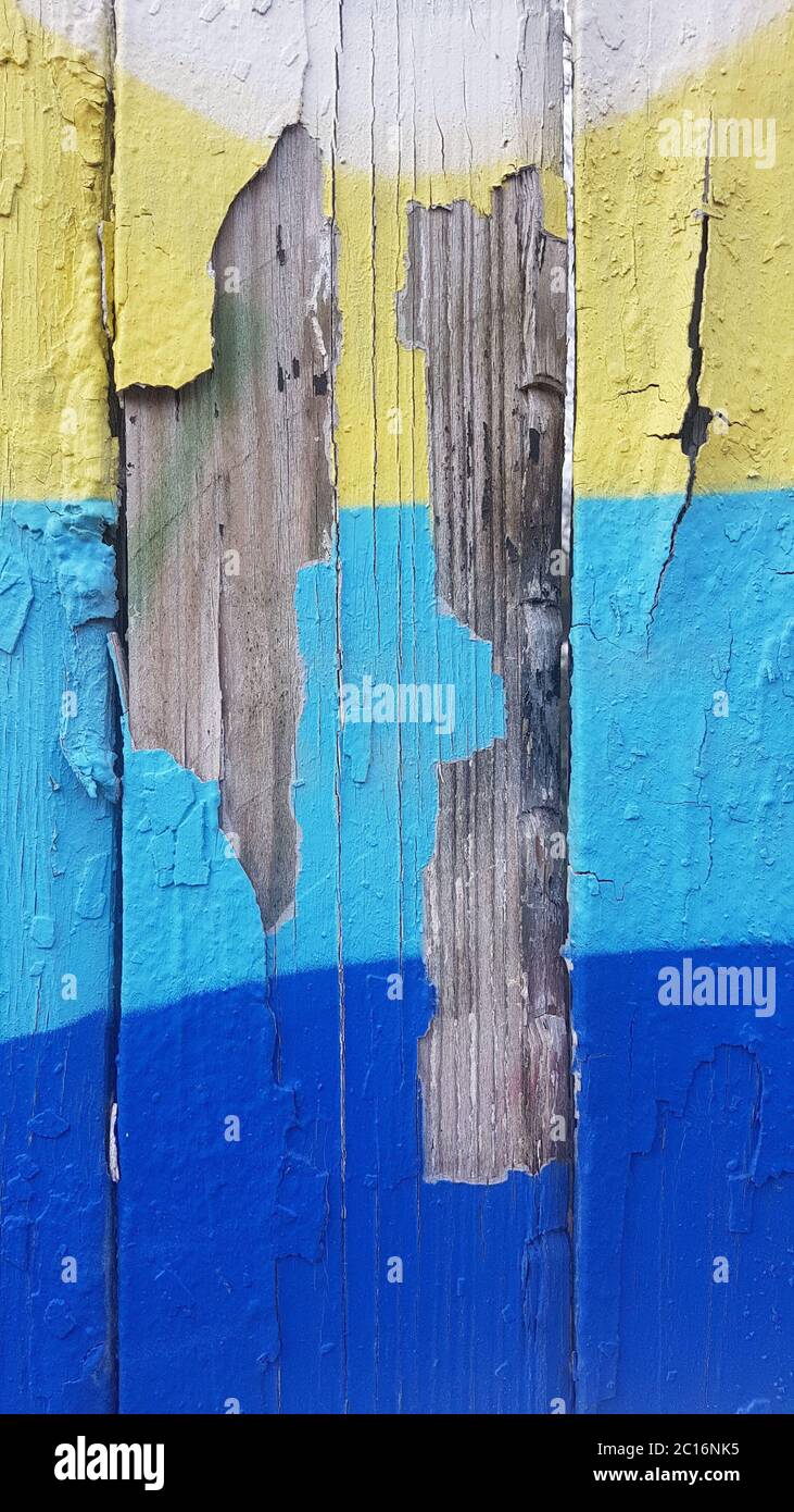 Old weathered paint that separated from old wood and peels off Stock