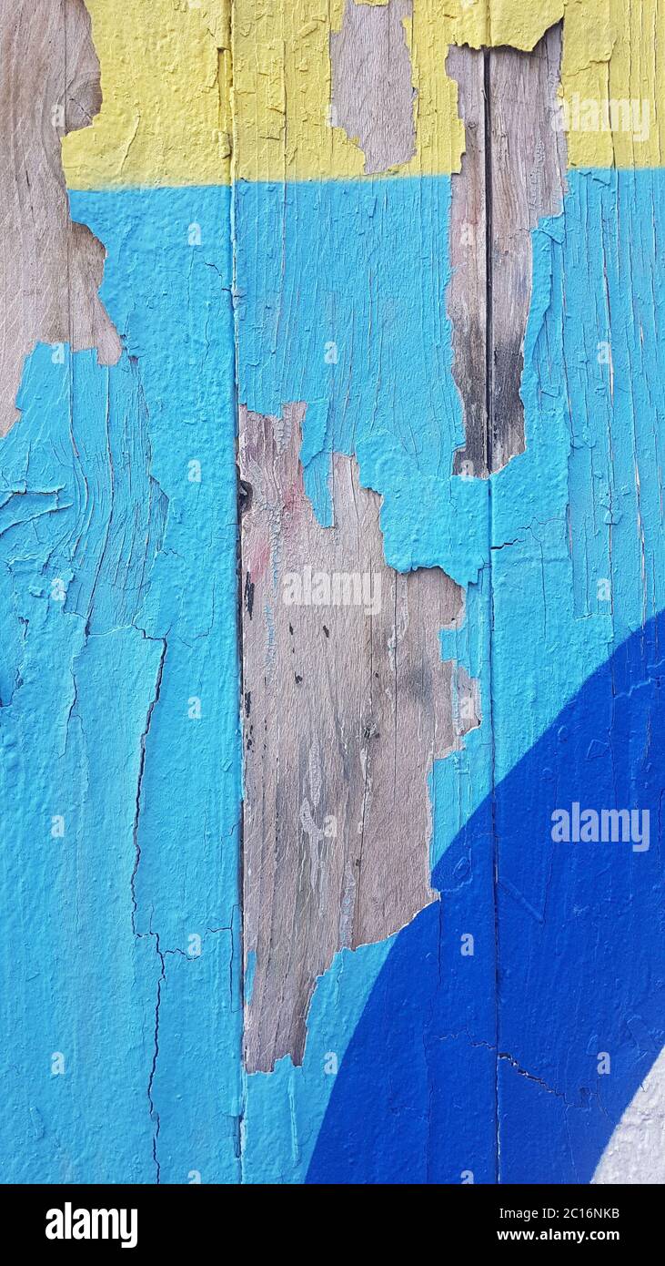 Old weathered paint that separated from old wood and peels off Stock