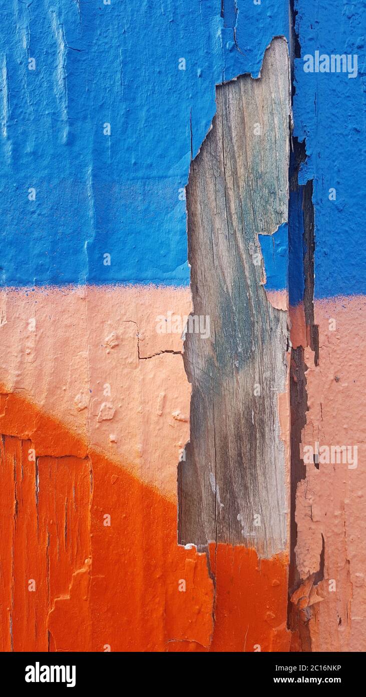 Old weathered paint that separated from old wood and peels off Stock