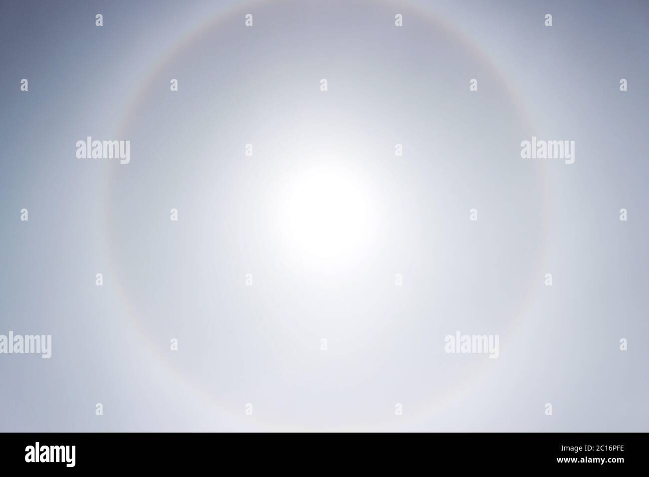 Halo a rainbow around the sun in the afternoon before the weather worsens. Stock Photo