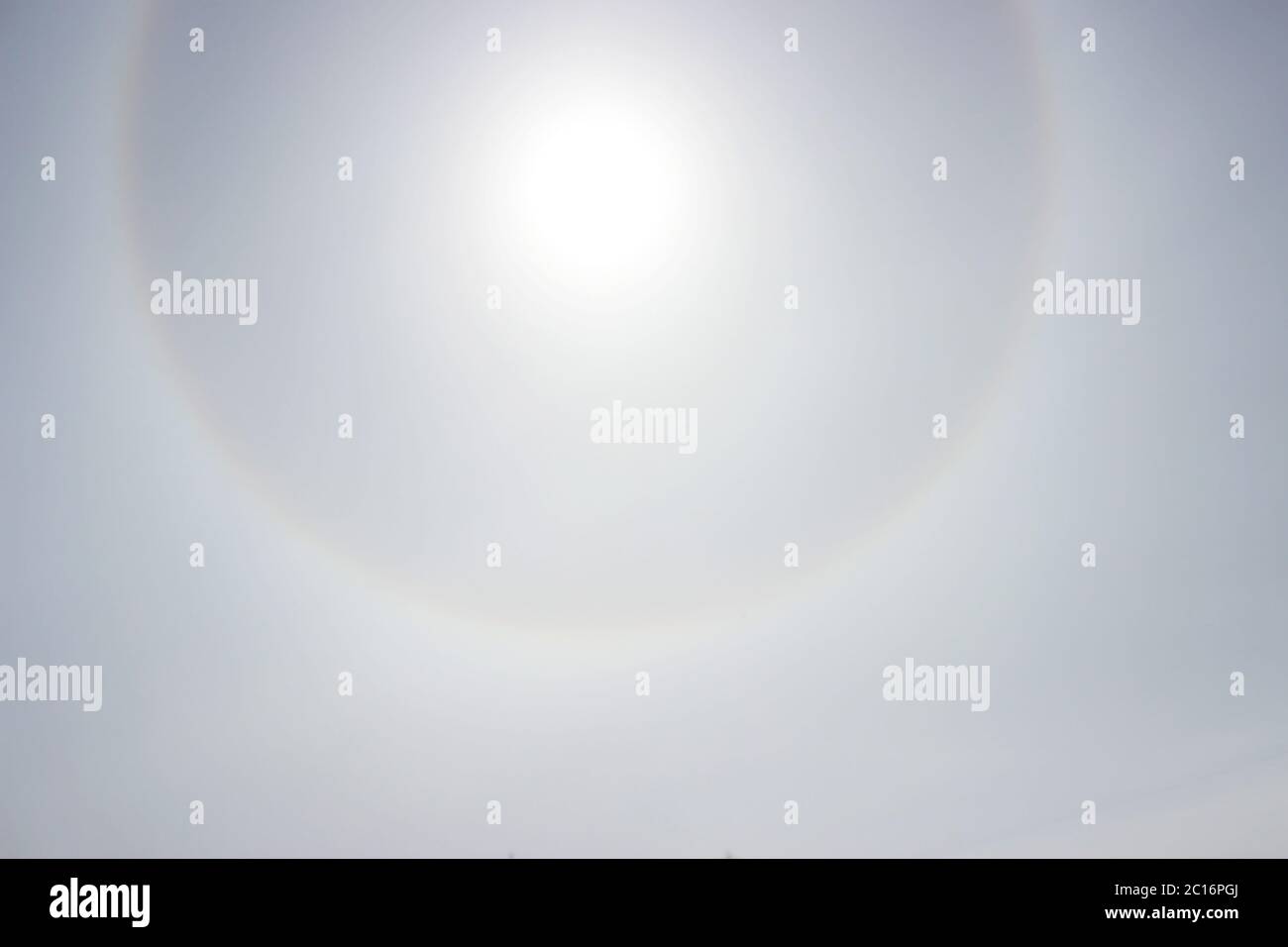 Halo a rainbow around the sun in the afternoon before the weather worsens. Stock Photo
