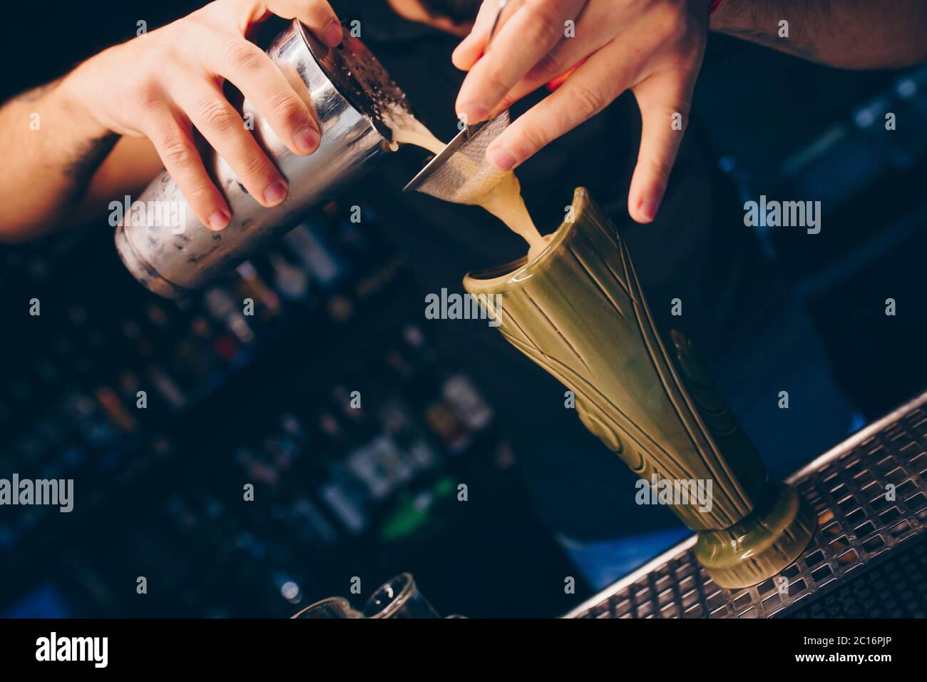 The hands of a professional bartender pour syrup into a measuring glass of  jigger in a metal tool for preparing and stirring alcoholic cocktails of sh  Stock Photo - Alamy