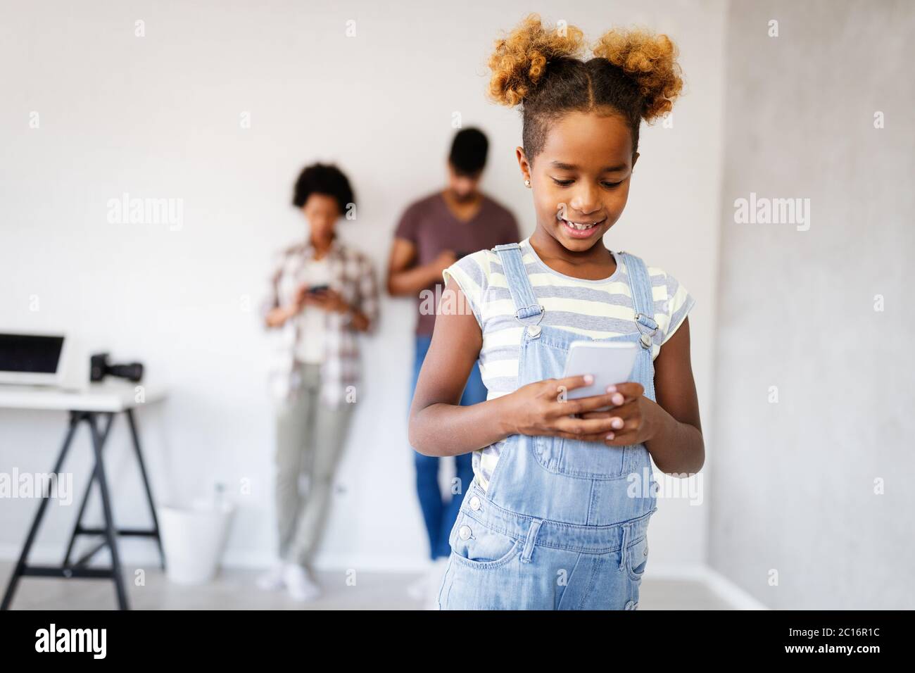 Children, technology and communication concept. Smiling girl using smartphone Stock Photo