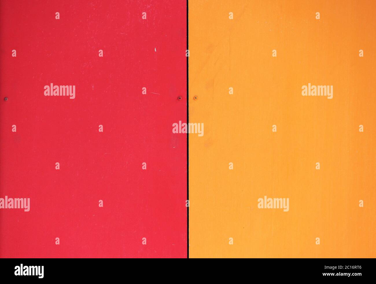 The wall of the house, trimmed with colorful panels, painted in bright colors. Red and orange. Stock Photo