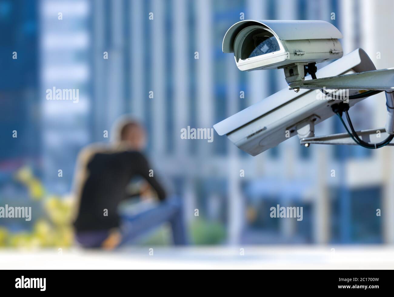 security CCTV camera or surveillance system with young man on blurry