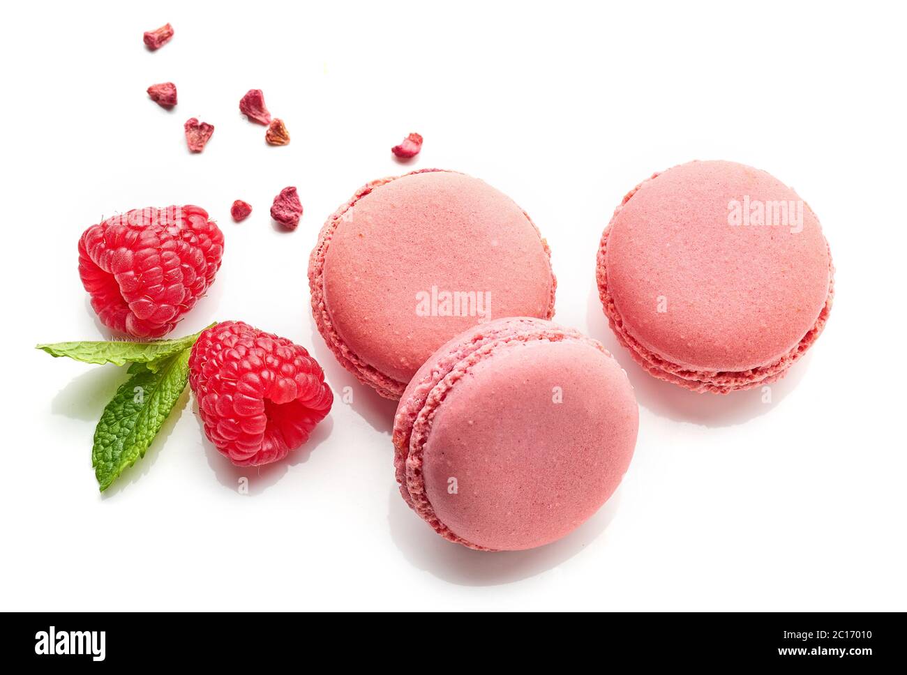 pink raspberry macaroons isolated on white background, top view Stock Photo