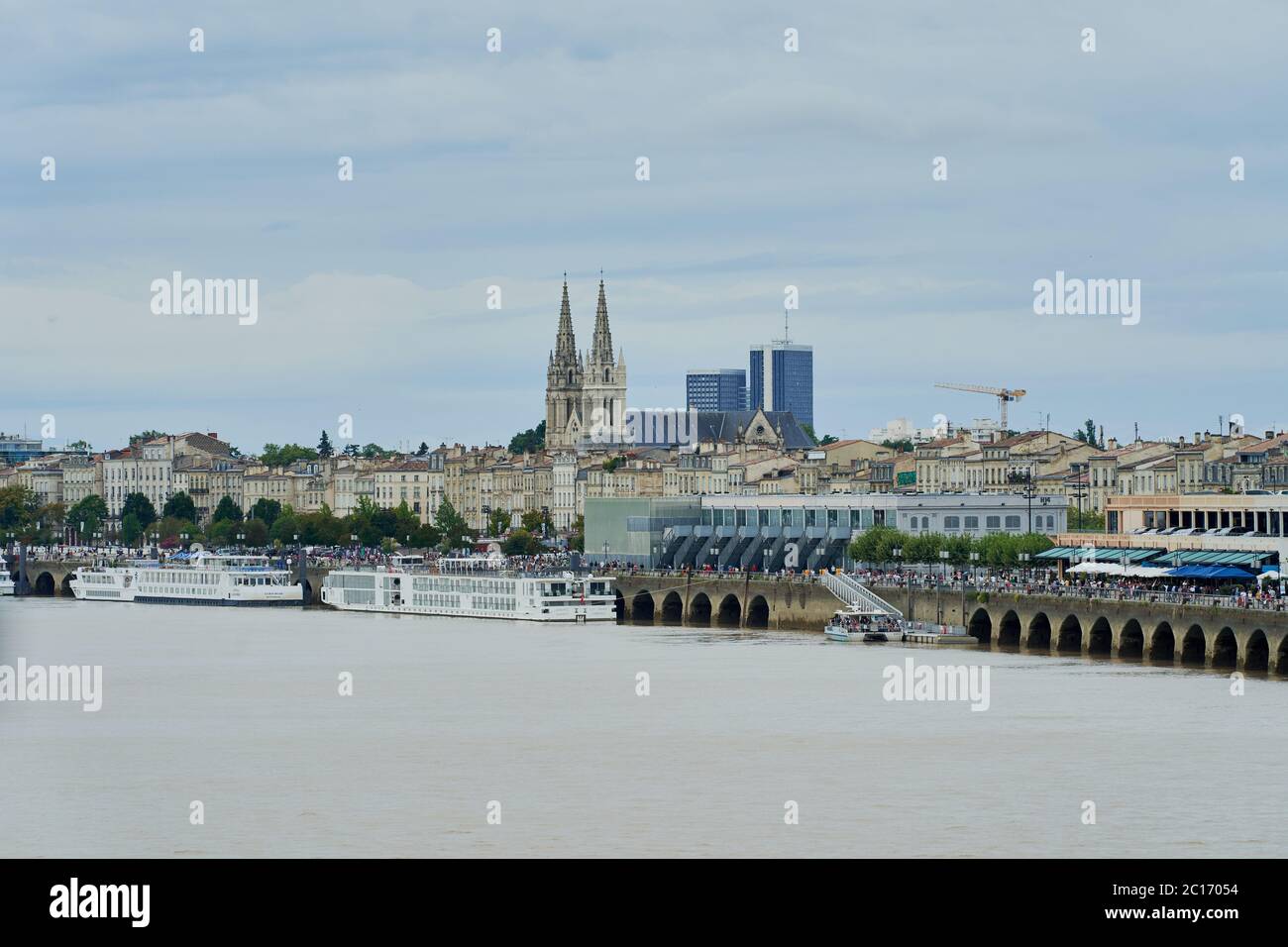 A view across the Garonne river to Saint-Louis Church of the Chatrons and Douane quay in Bordeaux, France Stock Photo