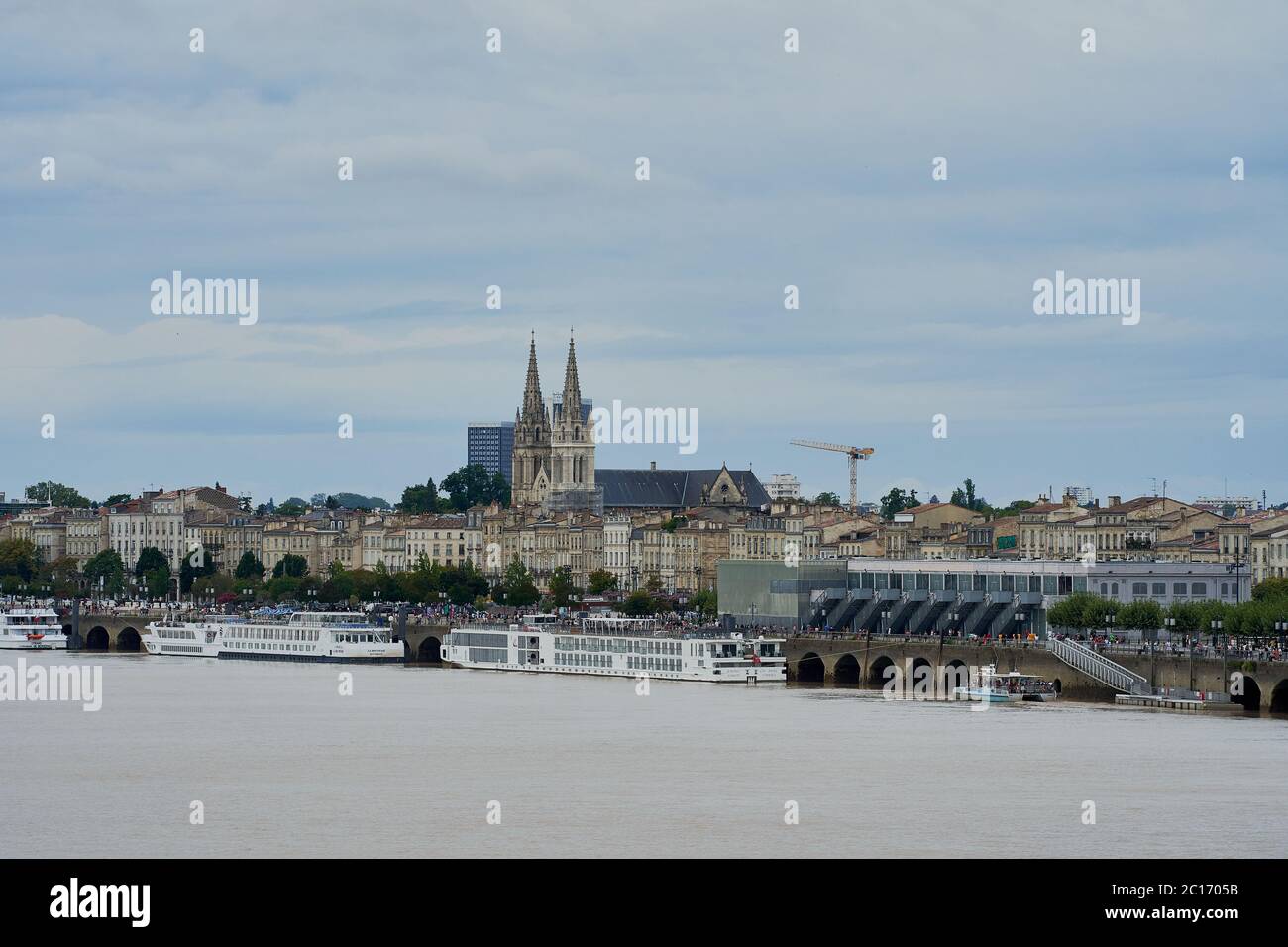 A view across the Garonne river to Saint-Louis Church of the Chatrons and Douane quay in Bordeaux, France Stock Photo