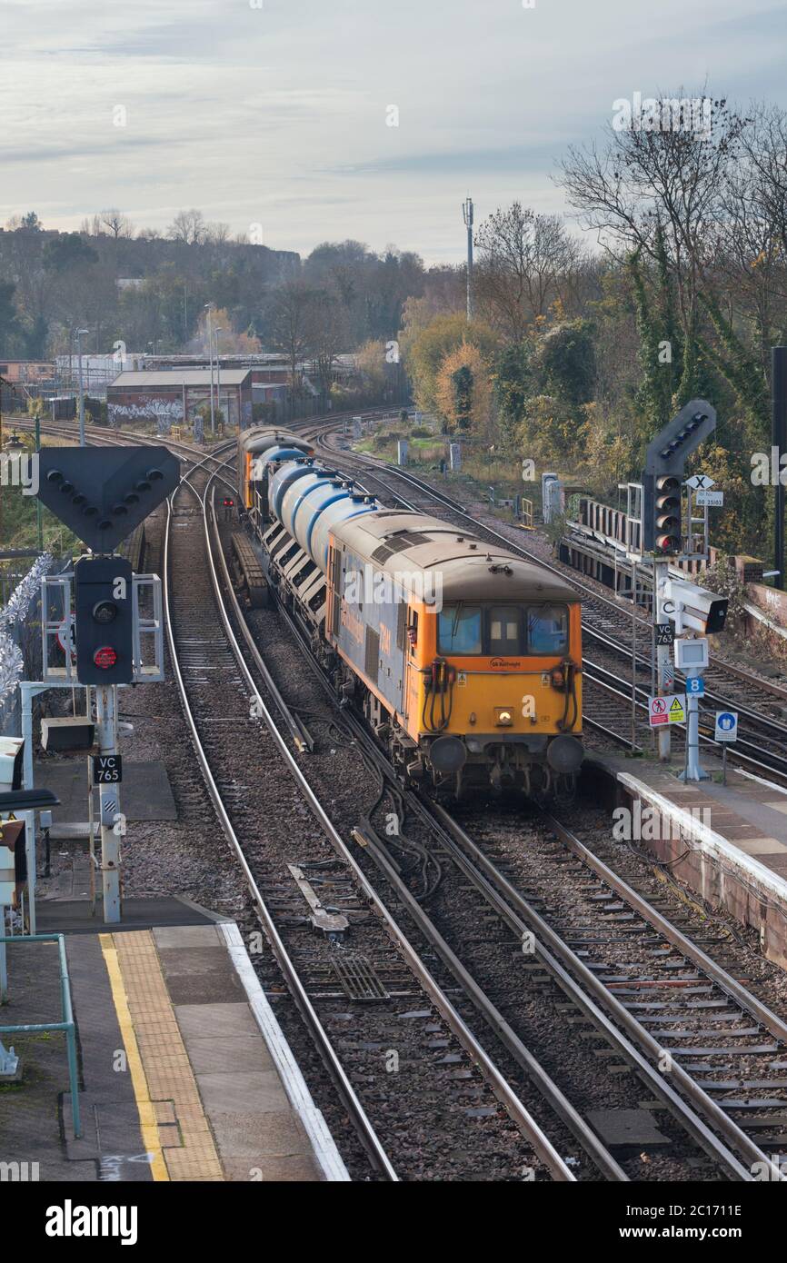 GB Railfreight class 73 dual mode locomotive line with a Network Rail railhead treatment train jetting autumn leaves from the line Stock Photo