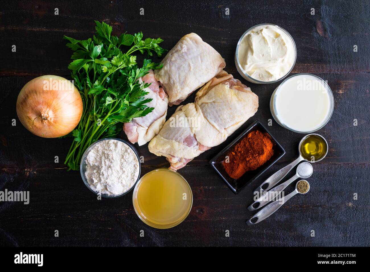 Hungarian Chicken Paprikash Ingredients: Chicken thighs, paprika, sour cream, and other ingredients for a traditional Hungarian dish Stock Photo