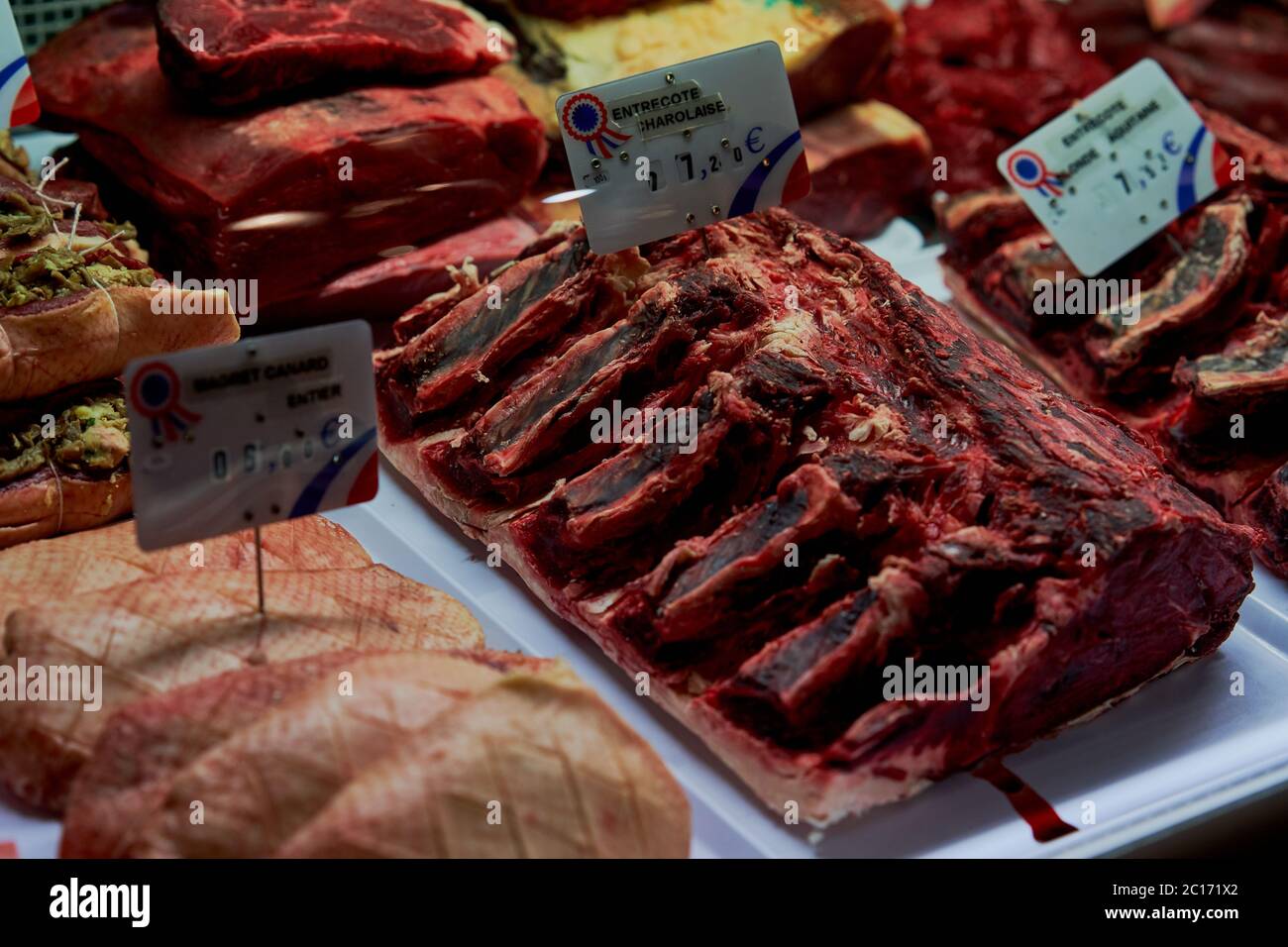 Raw red meat on display for customers to select for cooking at Butcher bar in Bordeaux city, France Stock Photo