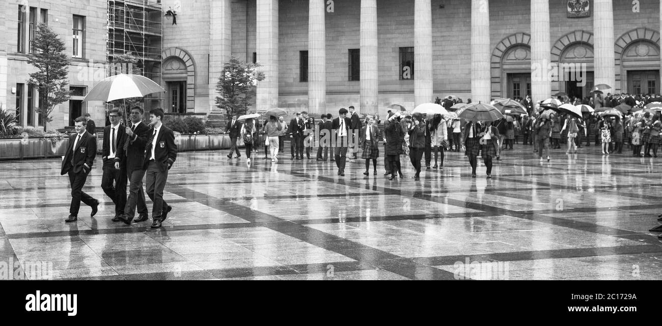 Monochrome (black and white) image of pupils, staff and parents of Dundee High School in City Square, Dundee after the school's graduation ceremony in the Caird Hall. Stock Photo