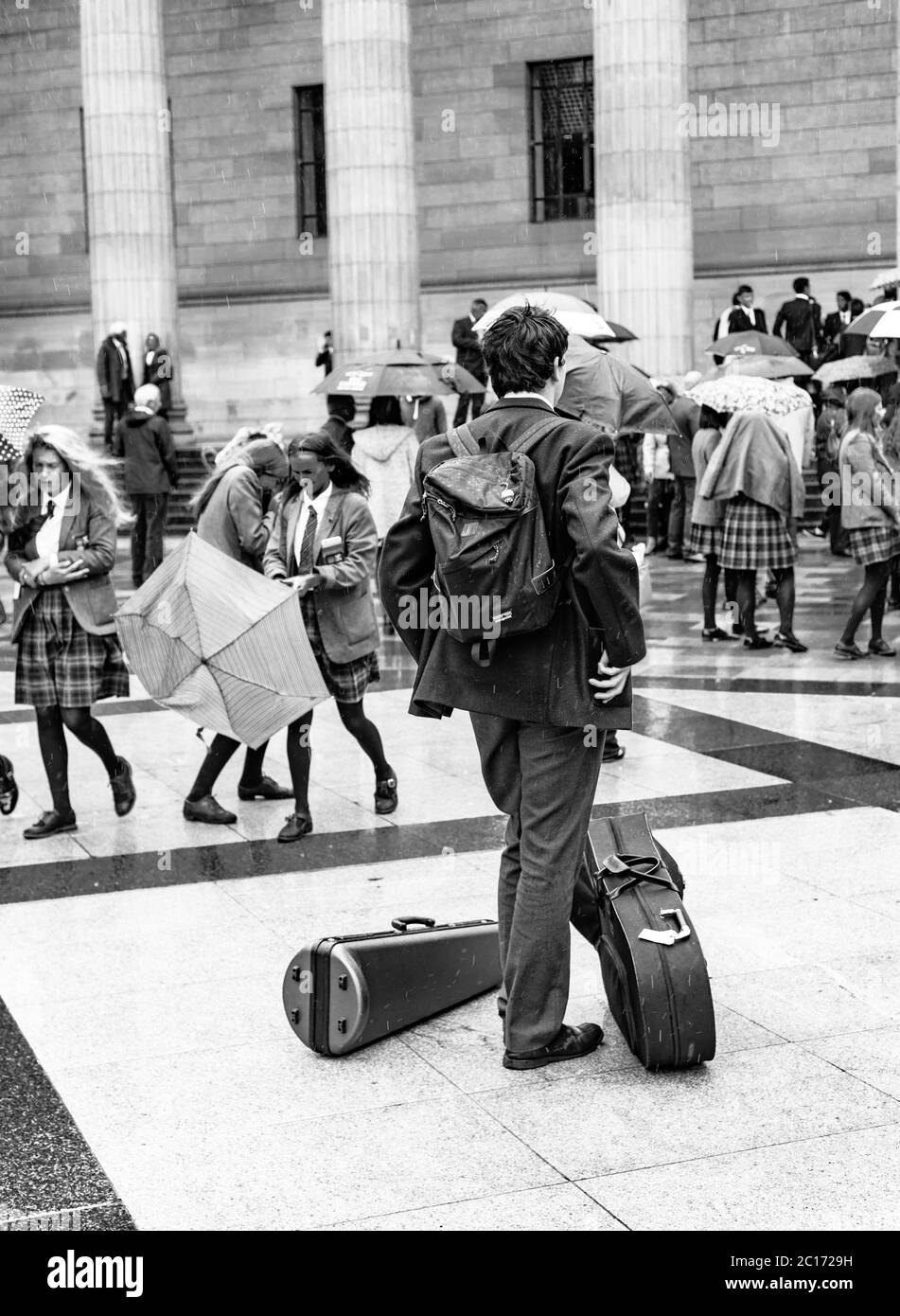 Monochrome (black and white) image of a pupil of Dundee High School in City Square, Dundee after the school's graduation ceremony in the Caird Hall. Stock Photo