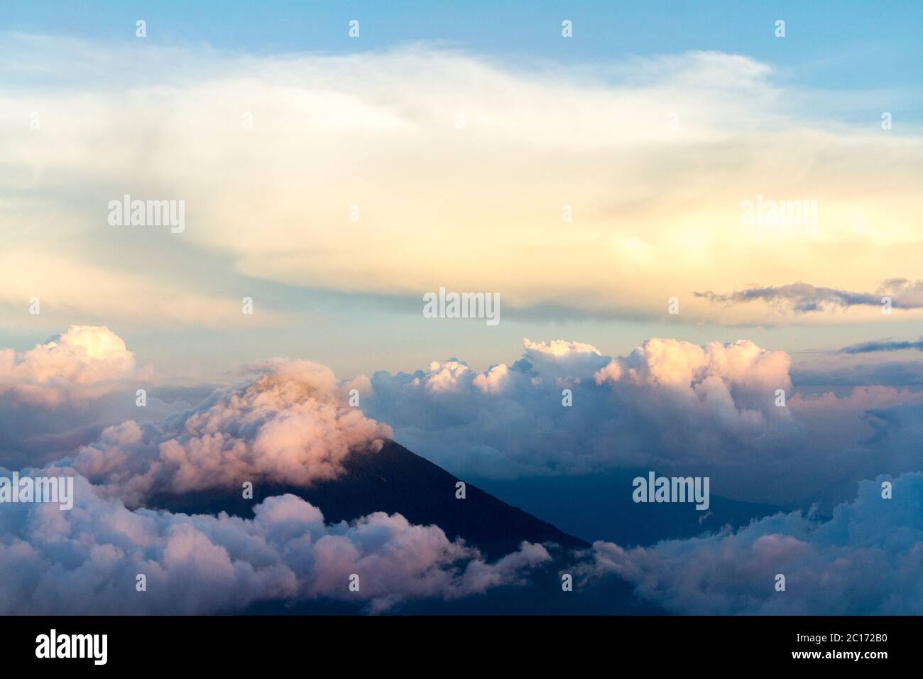 Clouds covering Fuego volcano during sunset, viewed from Acatenango, Guatemala - Stock Image