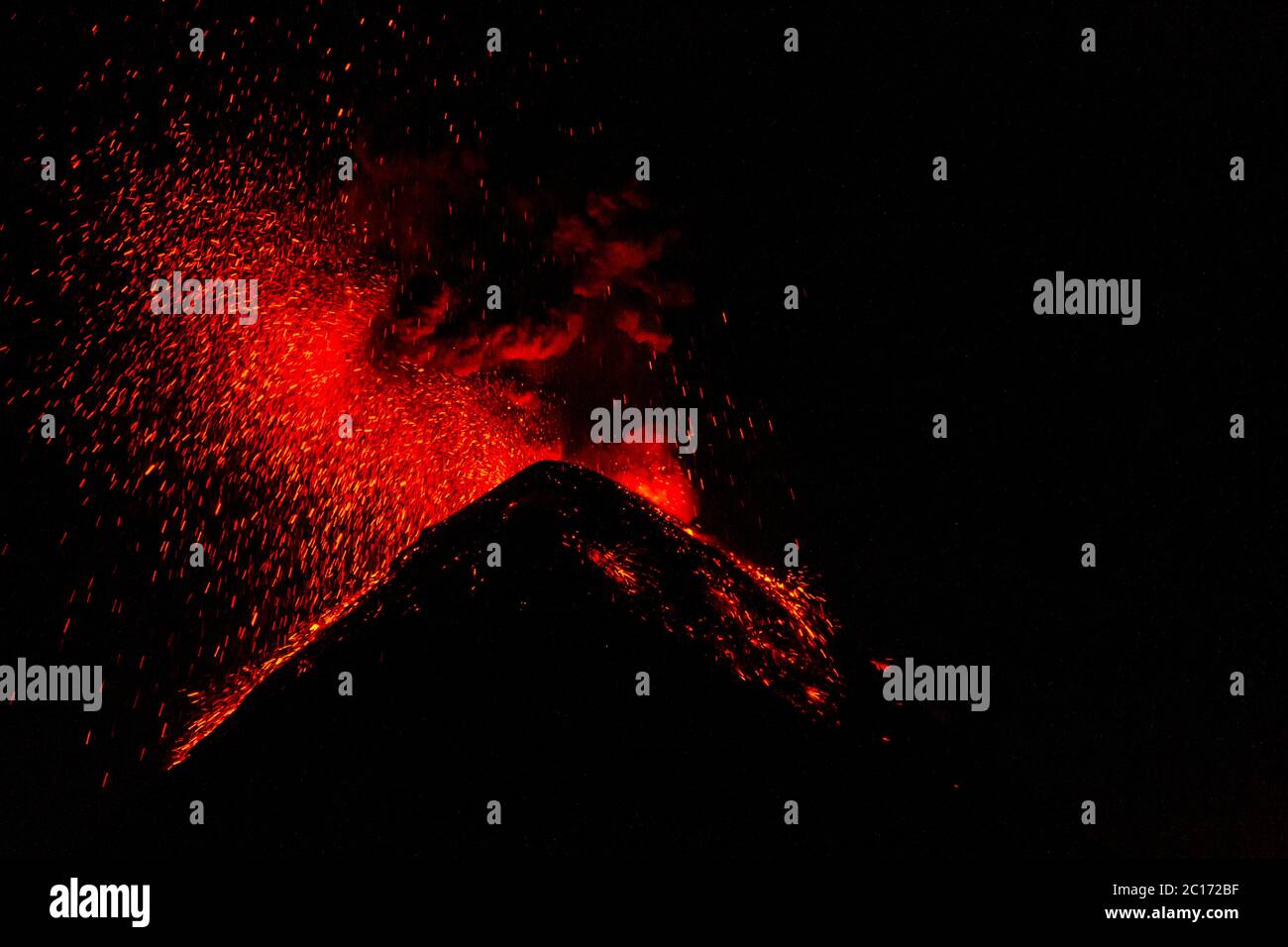 A close-up of the lava exploding from Fuego volcano at night viewed from basecamp on Acatenango volcan. - Stock Image