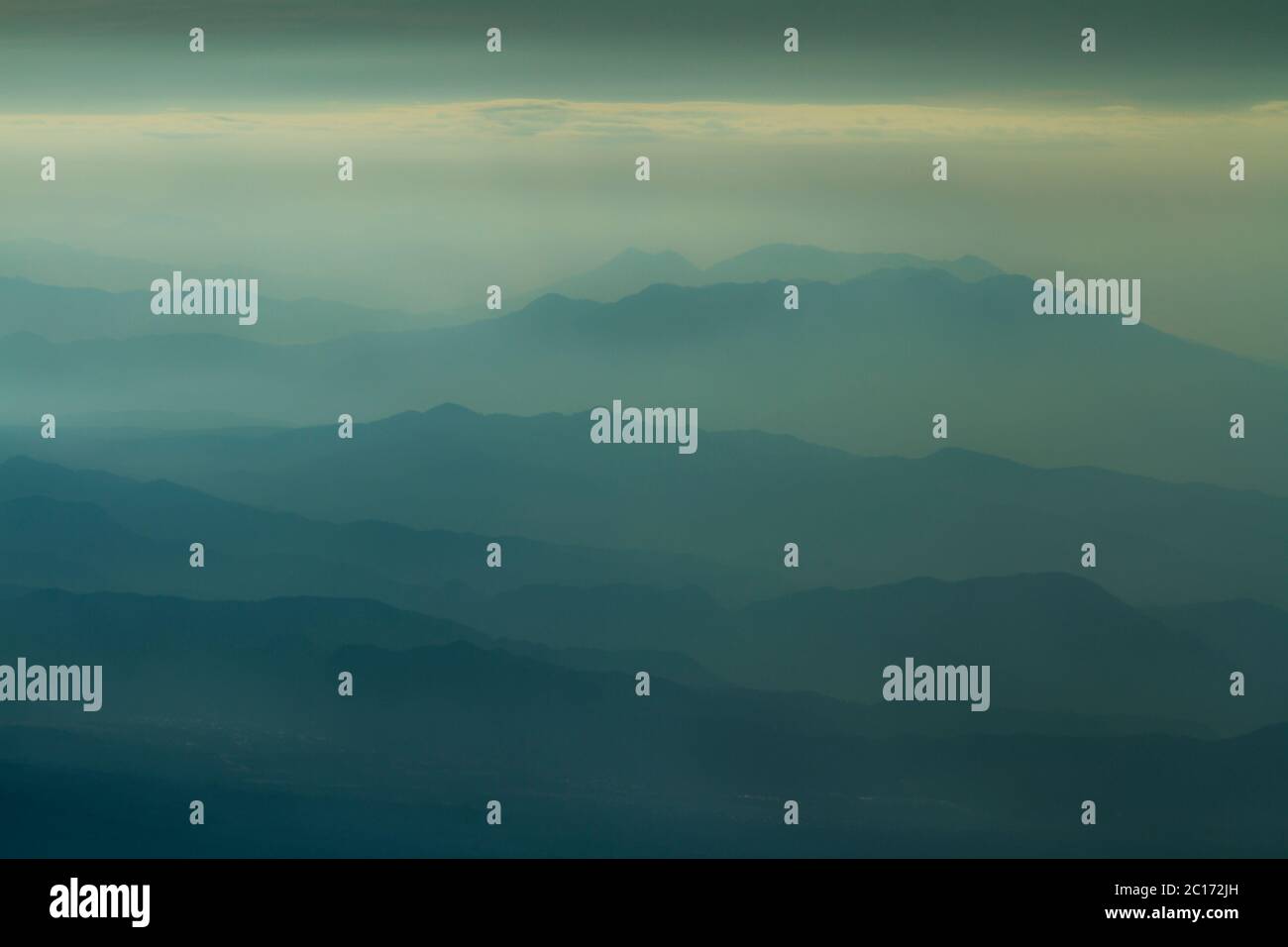 View down a valley from Acatenango volcano during sunrise - Stock Image