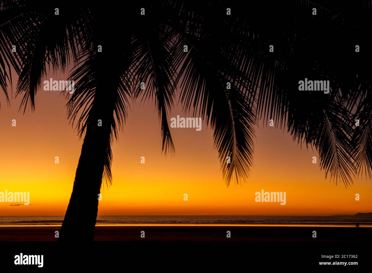 Orange sky after the sun had just set on Playa Coyote, Nicoya Peninsula, Costa Rica. - Stock Image