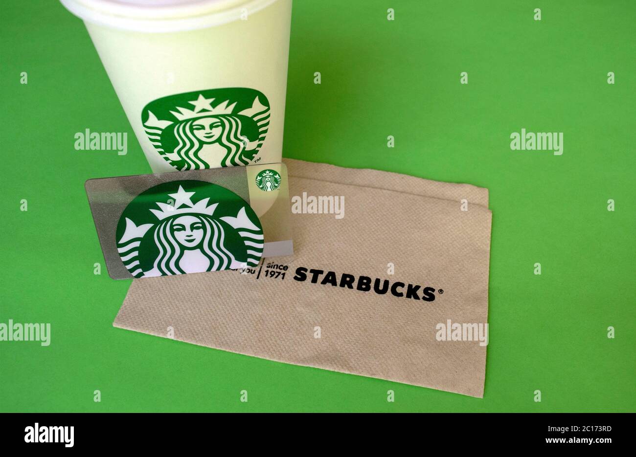 https://c8.alamy.com/comp/2C173RD/dubai-uae-june-7-2020-starbucks-white-coffee-cup-with-gift-card-and-napkin-on-green-background-with-copy-space-2C173RD.jpg