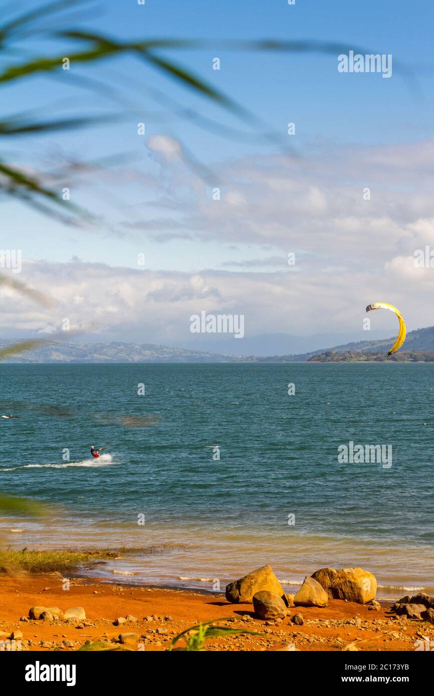 Lago Arenal is one of the best and well-known destination for windsurfers all around the globe. With views like these and constant winds, it's easy to - Stock Image