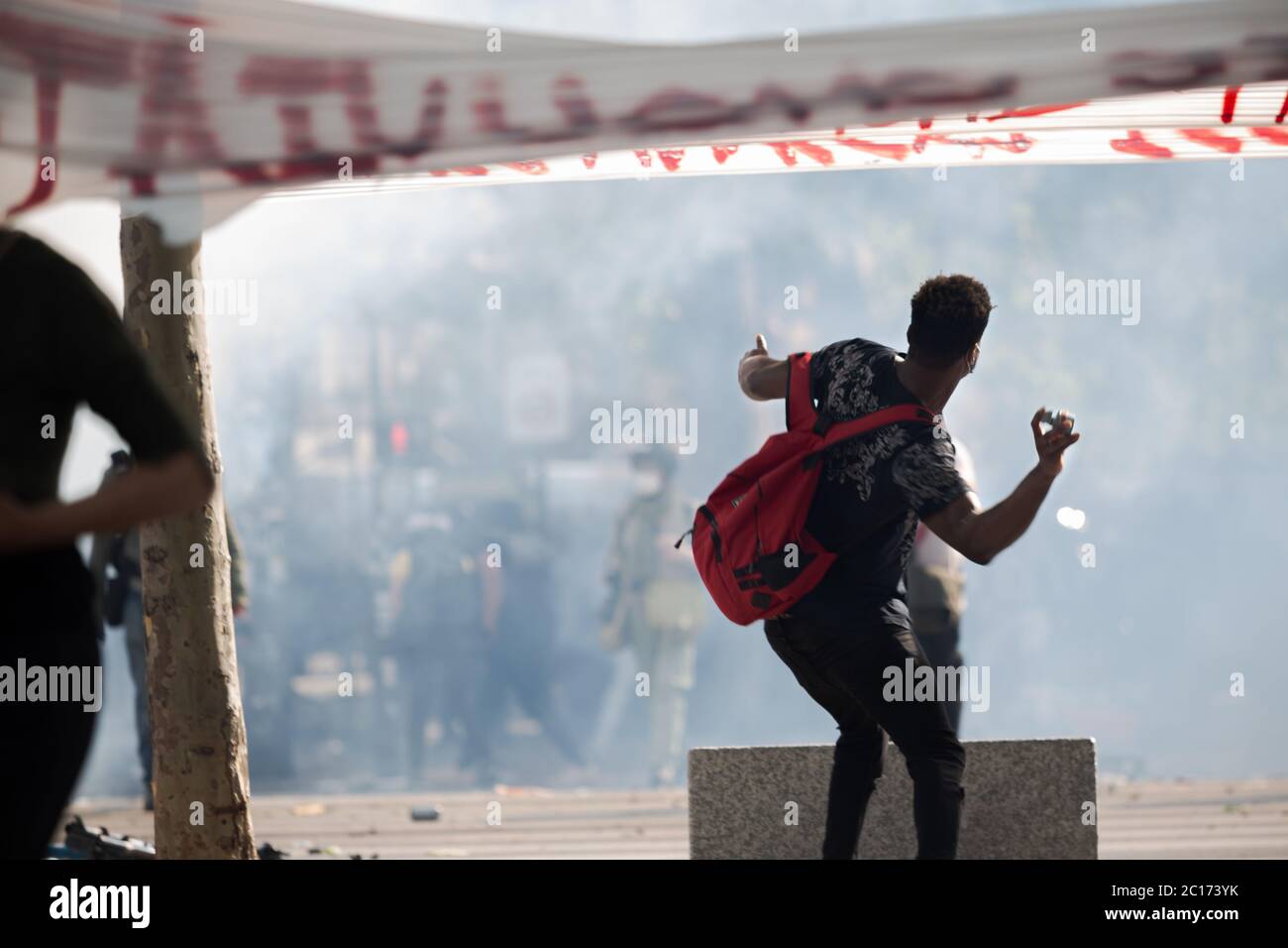 Paris, France. 13th June, 2020. A protester throws an object at police during a Black Lives Matter demonstration at Place de la Republique in Paris, France, on June 13th, 2020. (Photo by Daniel Brown/Sipa USA) Credit: Sipa USA/Alamy Live News Stock Photo