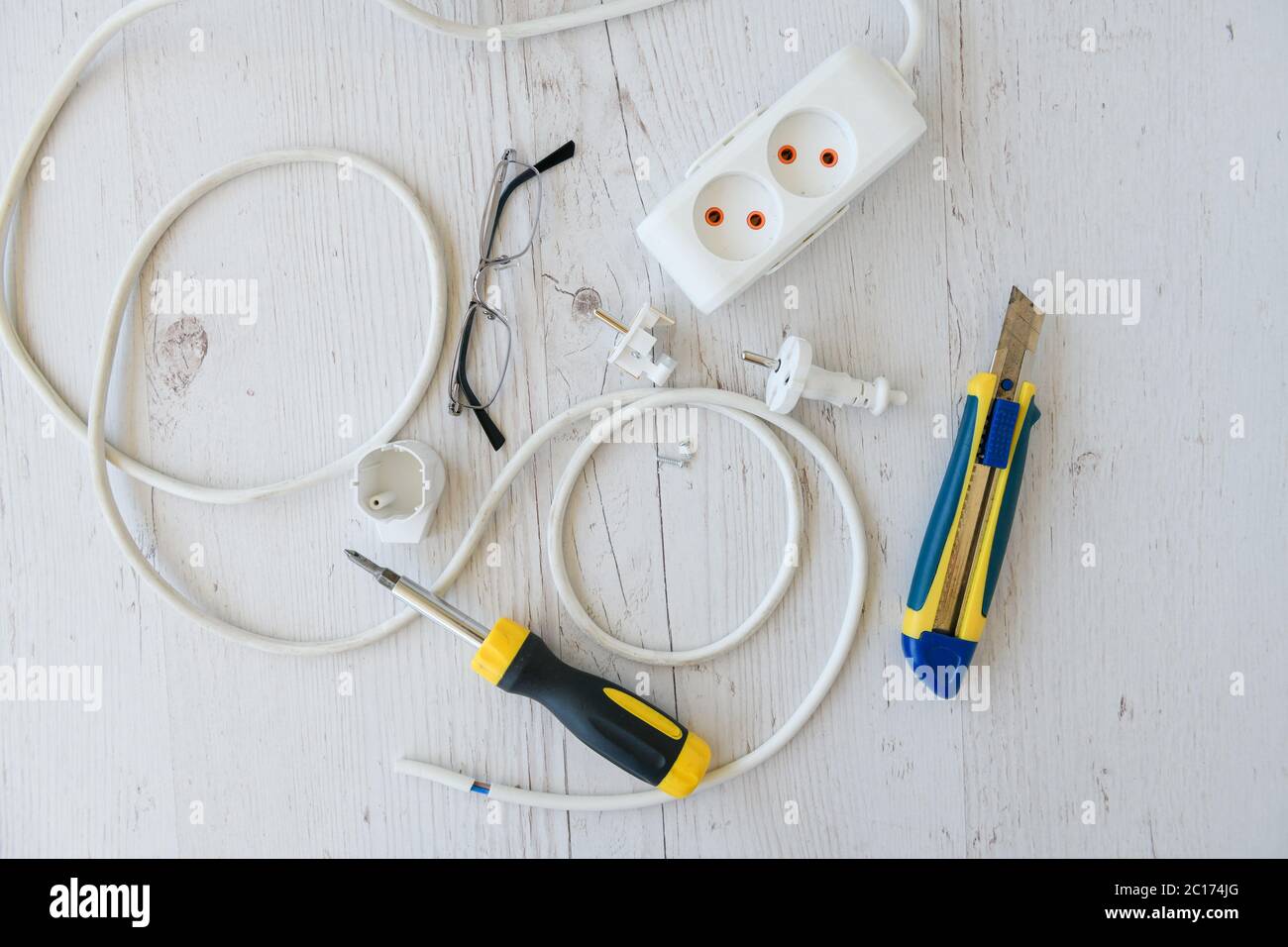Repair electric extension plug cord with tools Stock Photo - Alamy