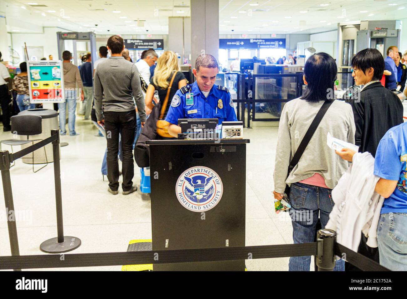 Miami Florida International Airport MIA,aviation,Department of Homeland Security,TSA,checkpoint,anti terrorism,safety,Hispanic ethnic man men male adu Stock Photo