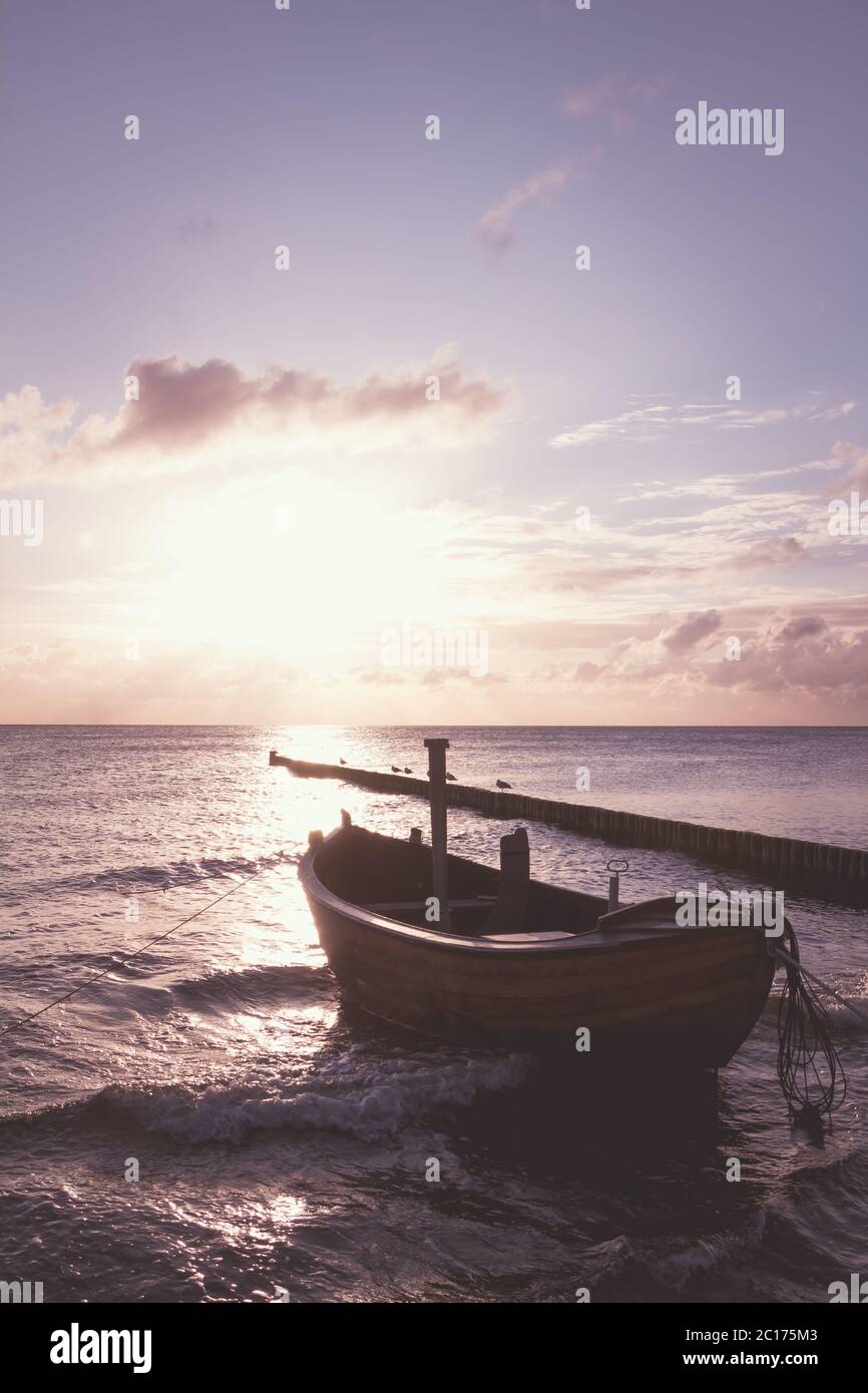 Coastline with a special dreamy mood on the beach with a wooden boat Stock Photo
