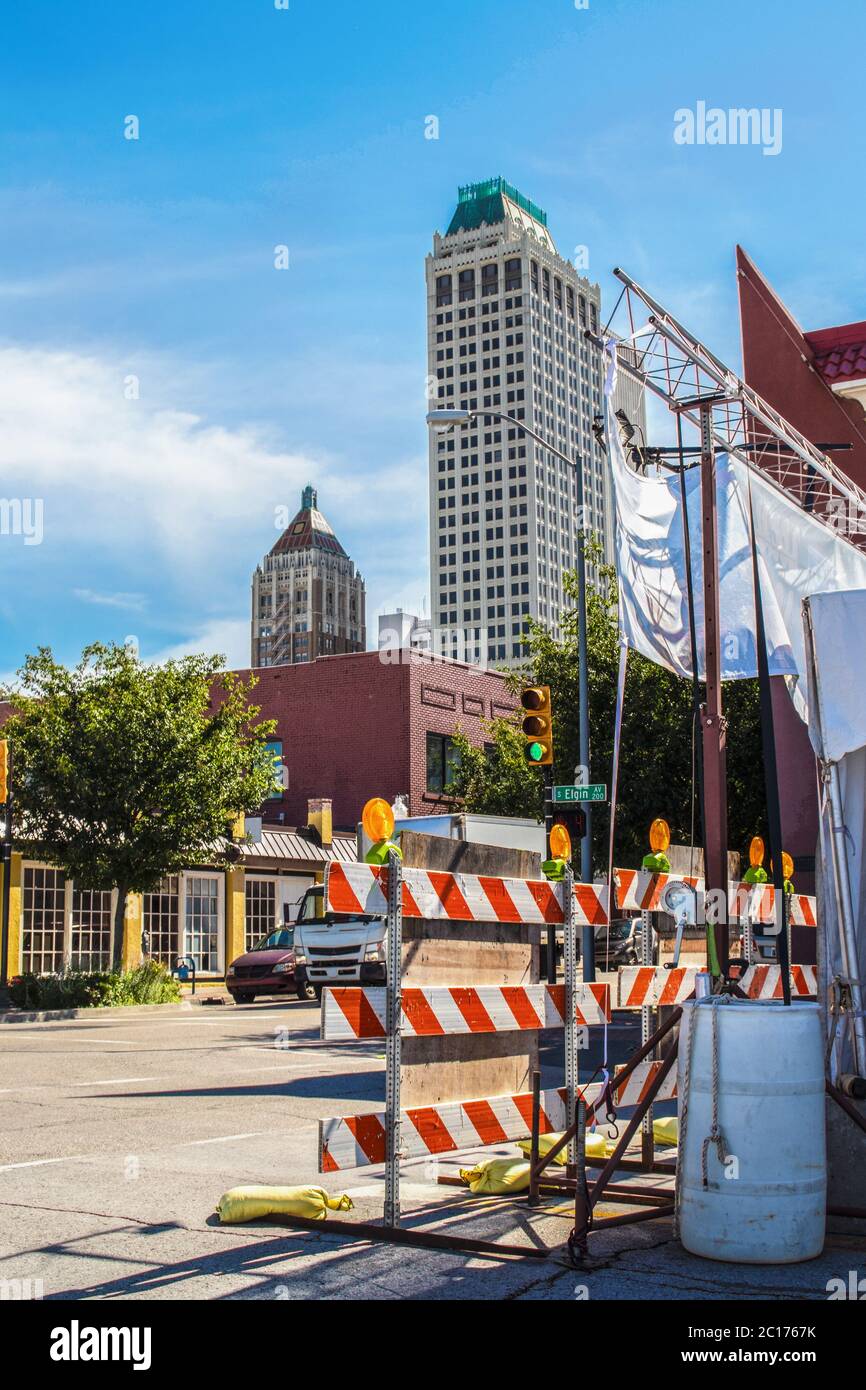 05-21 Tulsa USA - Event road closure near downtown Tulsa with stoplight and safety barriers and Art Deco skyscrapers Stock Photo