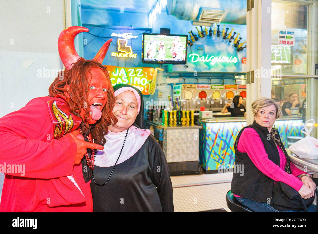 New Orleans Louisiana,French Quarter,daiquiris,bar lounge pub,red devil,horns,nun,religion,funny,humor,humorous,humour,humorous,costume,masquerade,rev Stock Photo