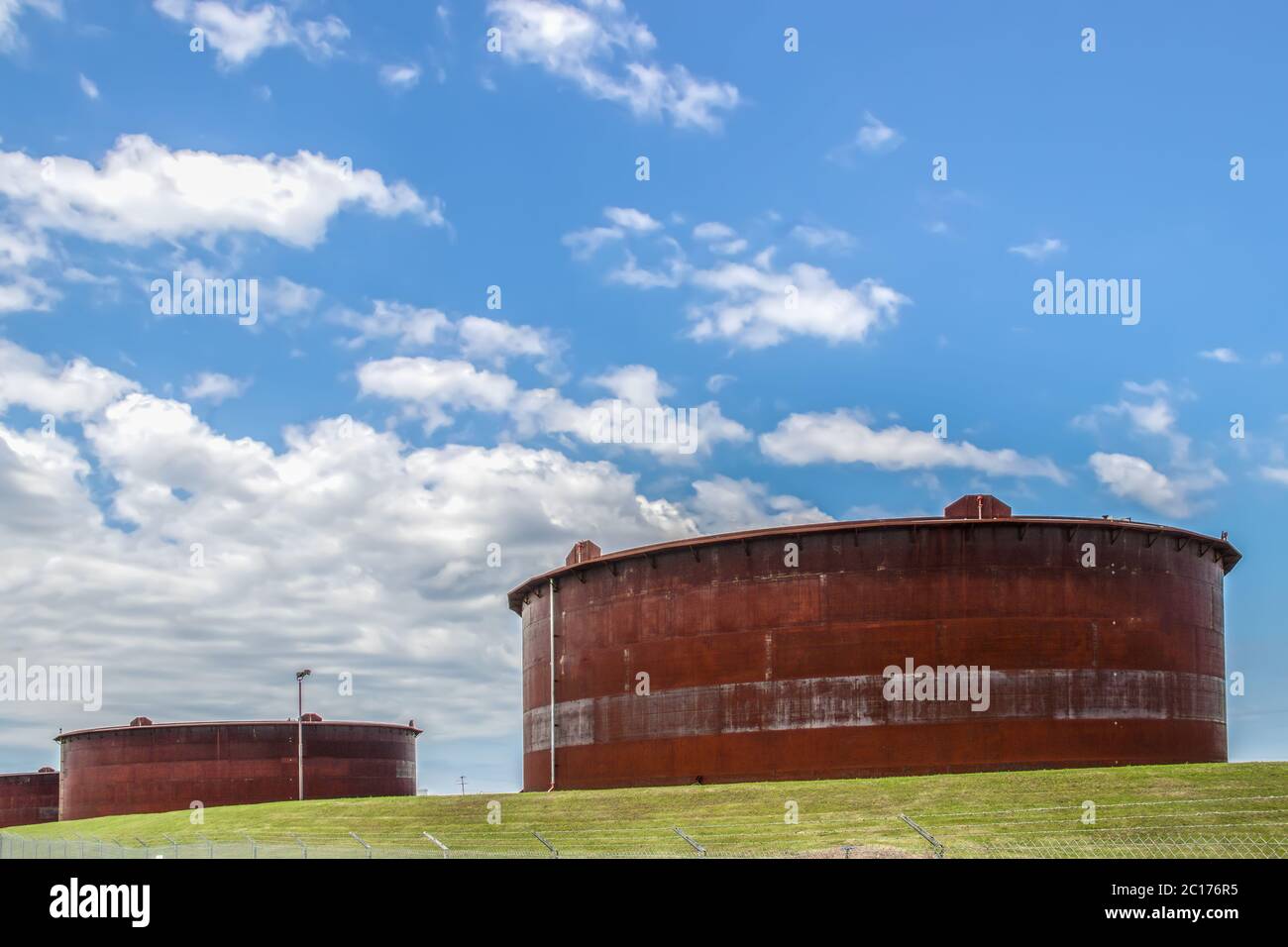 Huge rusty storage tanks full of petroleum products in tank farm in Cushing Oklahoma where most oil in USA is stored and traded Stock Photo