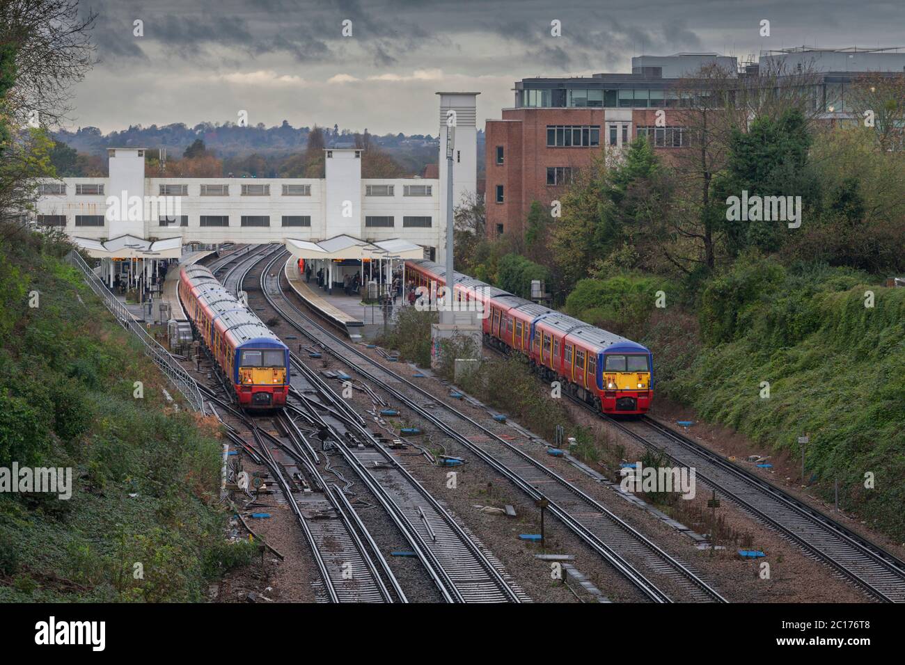 South West Trains class 456 inner suburban trains arriving and departing from Surbiton railway station on the busy south western main line Stock Photo