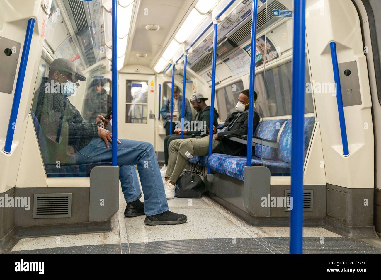 LONDON, ENGLAND JUNE 8, 2020 Group of men on a Piccadilly Line