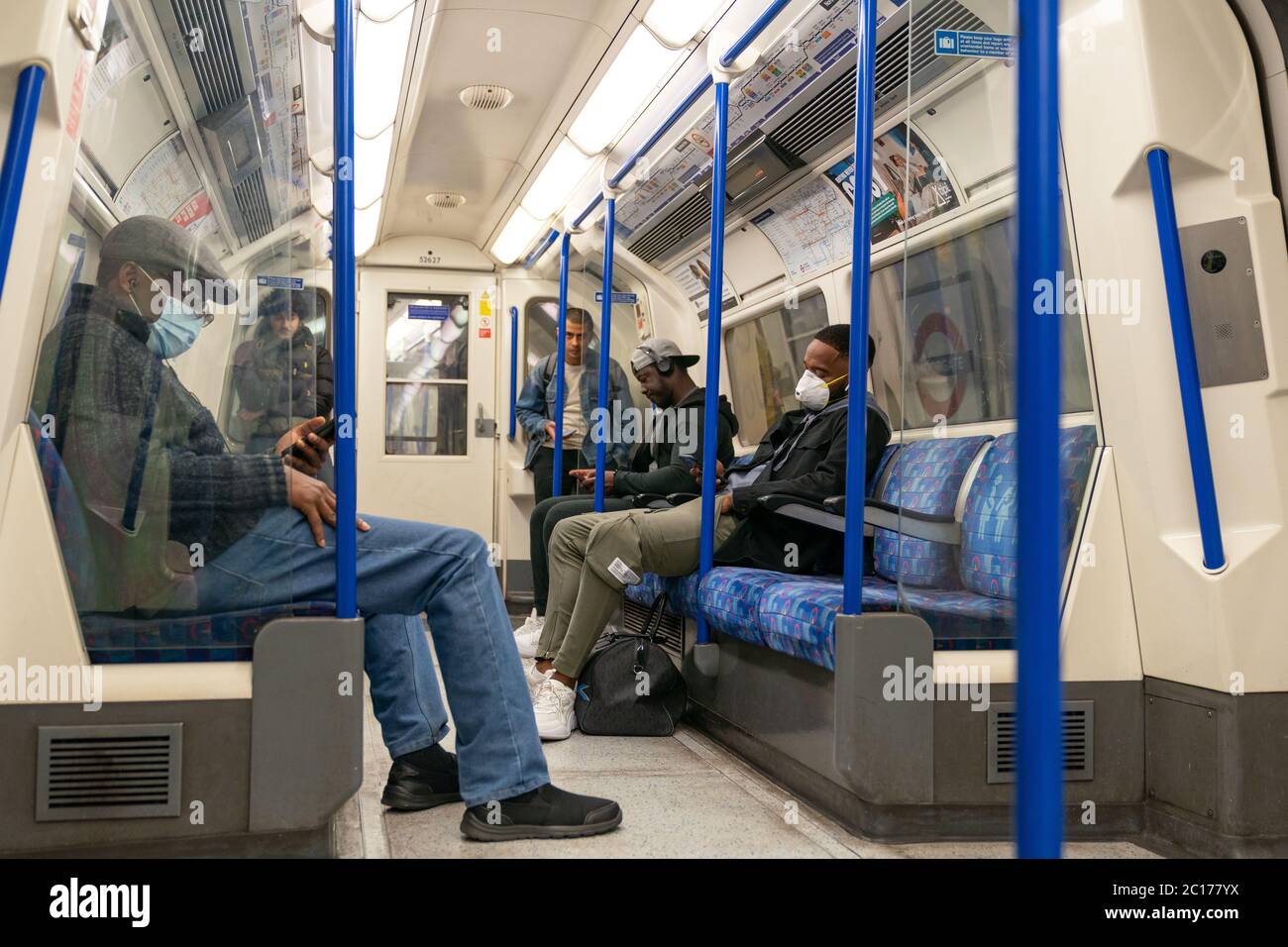 LONDON, ENGLAND JUNE 8, 2020 Group of men on a Piccadilly Line