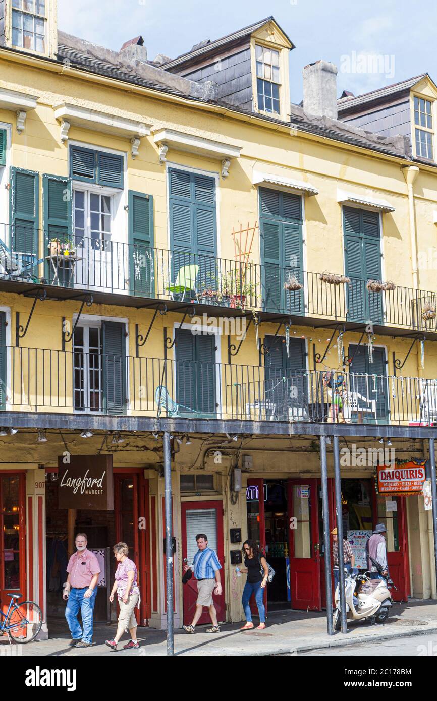 New Orleans Louisiana,French Quarter,907 Decatur,architecture heritage building,gallery,balcony,dormer window,man men male,woman female women,facade,L Stock Photo